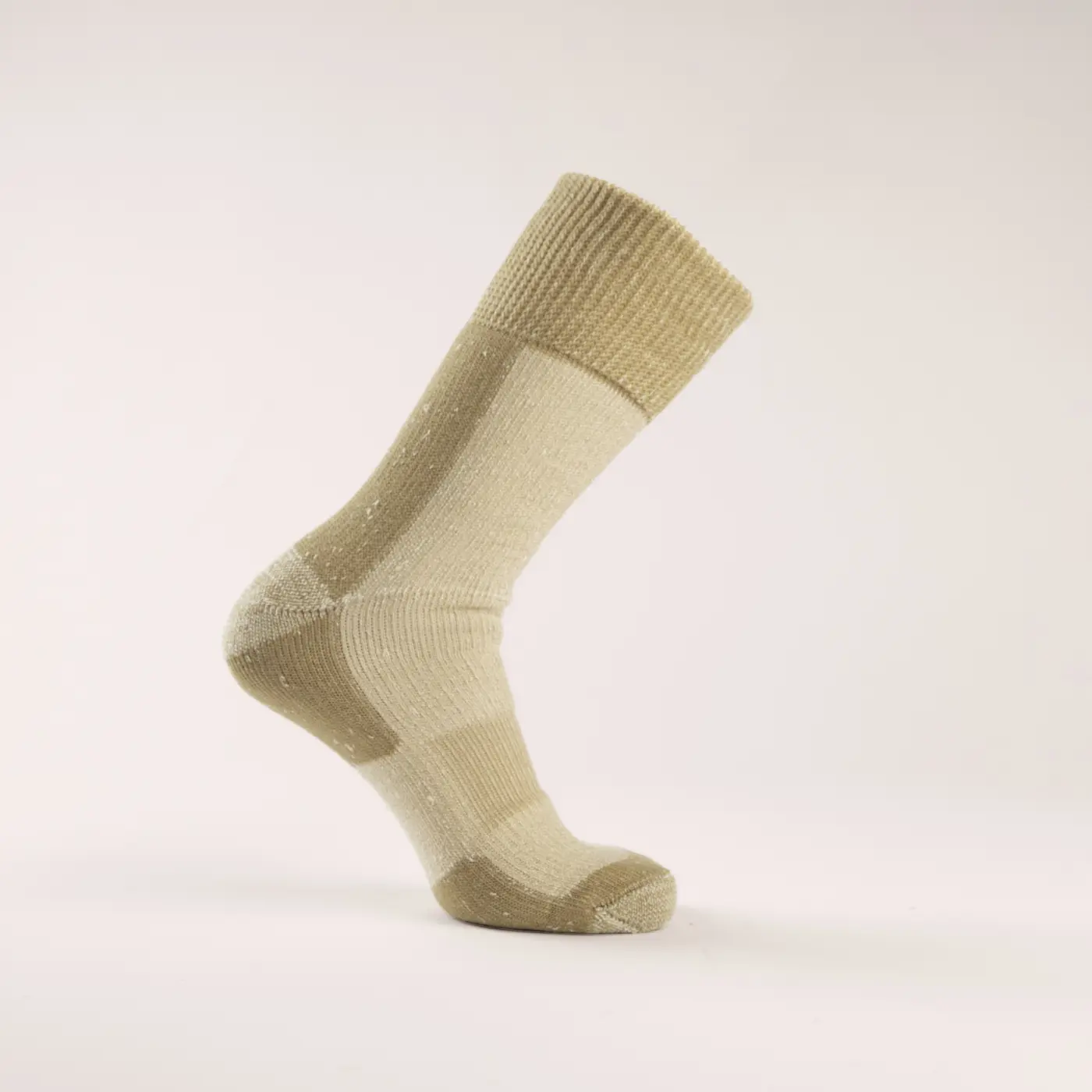 A single beige and cream sock is displayed upright against a plain white background, showing its ribbed cuff, reinforced heel, and toe areas.