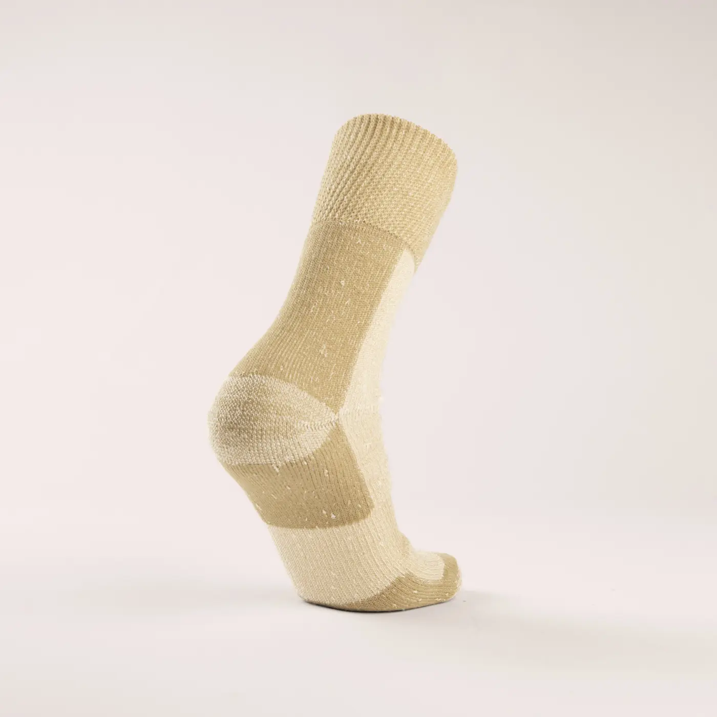 A single beige and cream speckled sock is displayed standing upright on a plain, light background, showing the heel and sole.