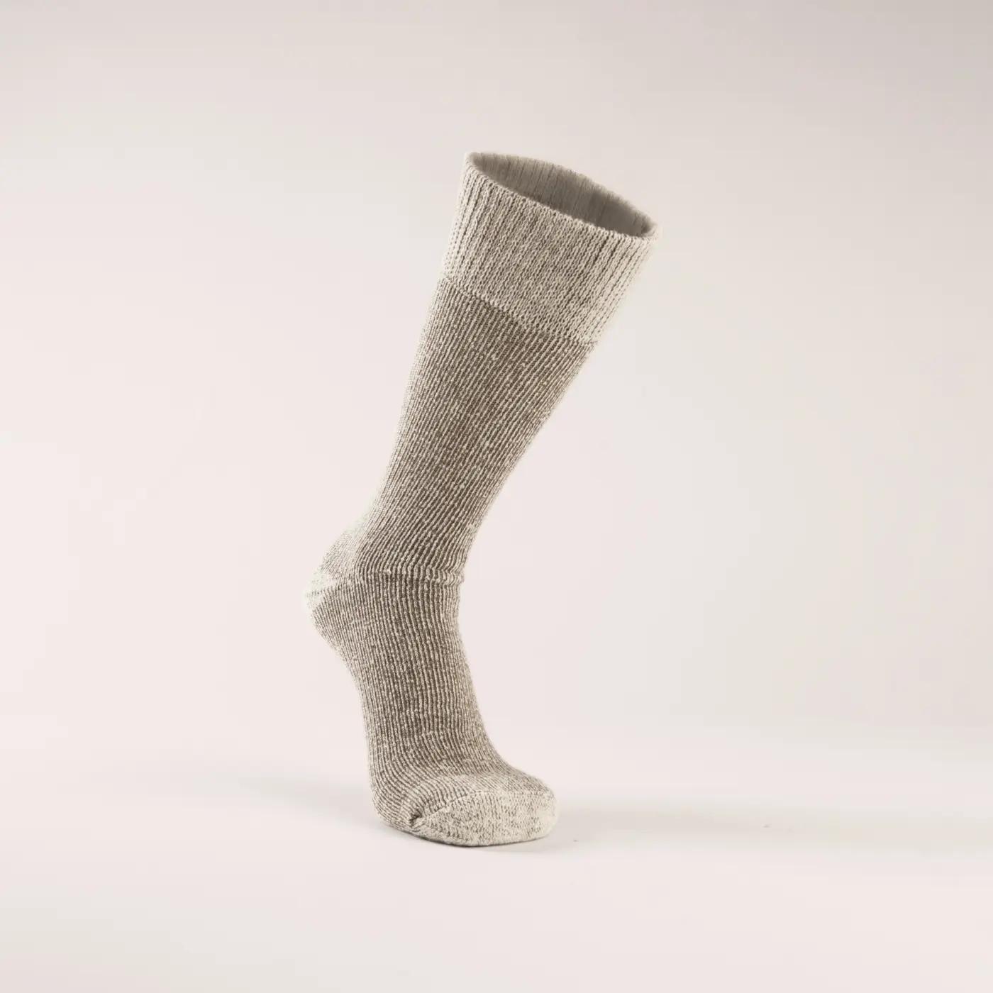 A single gray wool sock stands upright on a light, neutral background, displayed to show its length and texture.