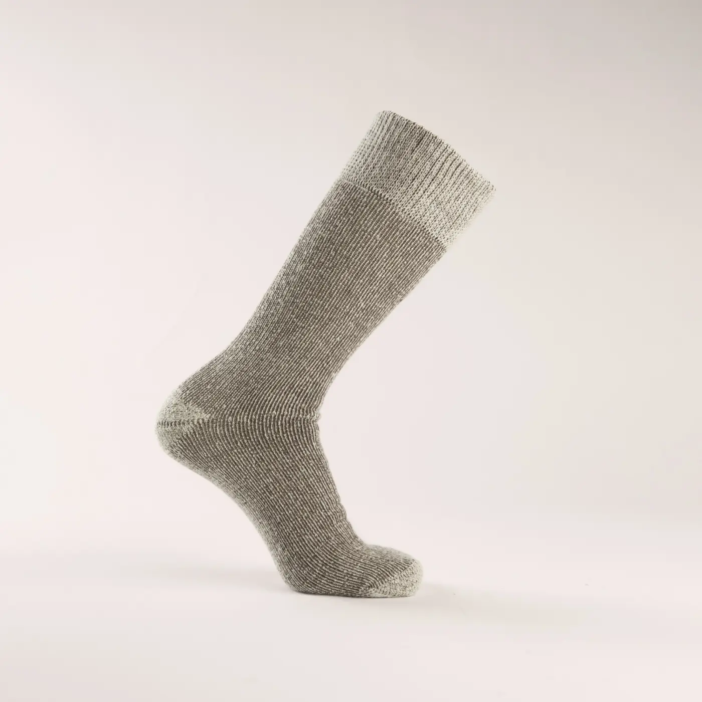 A single gray wool sock displayed on a foot-shaped mannequin against a plain, light background. The sock is mid-calf length and features a ribbed cuff at the top.