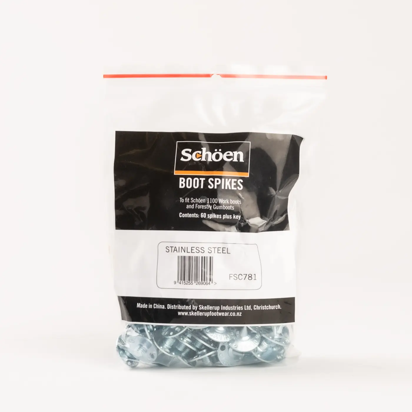 A clear plastic bag labeled Schöen Boot Spikes contains stainless steel boot spikes. The bag has a black and white label with product information and a visible barcode on the front.