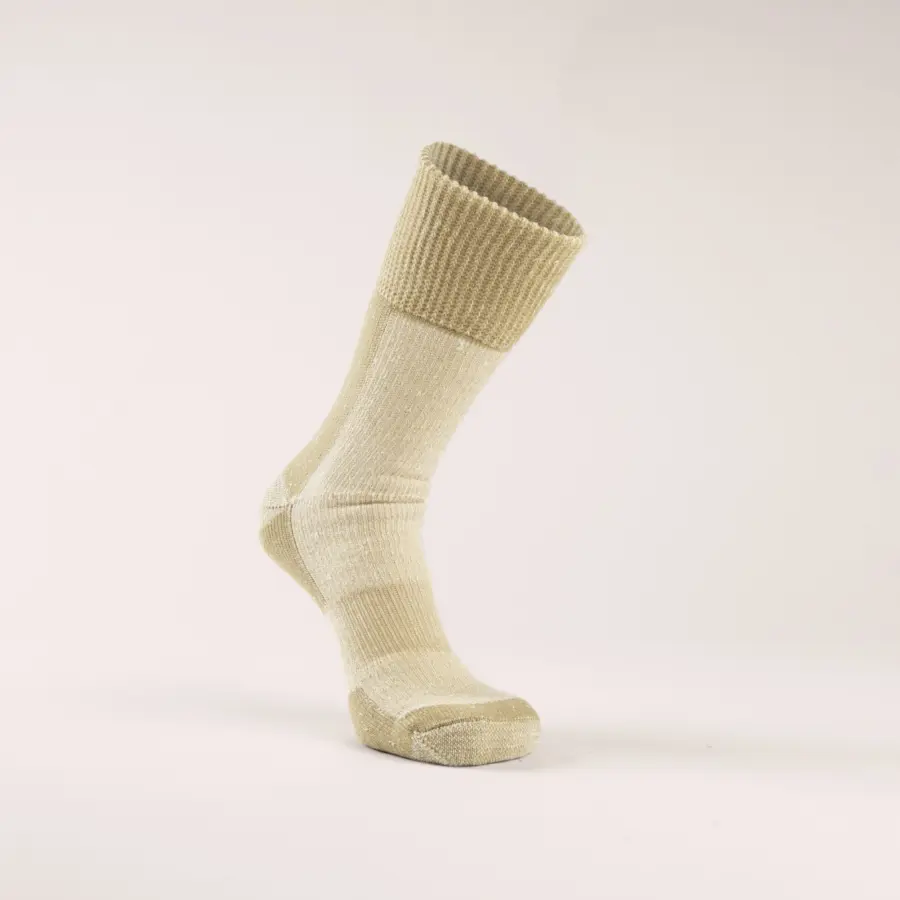 A single beige sock is standing upright on a plain, light background. The sock has a ribbed cuff and a heel and toe section in a slightly darker shade.