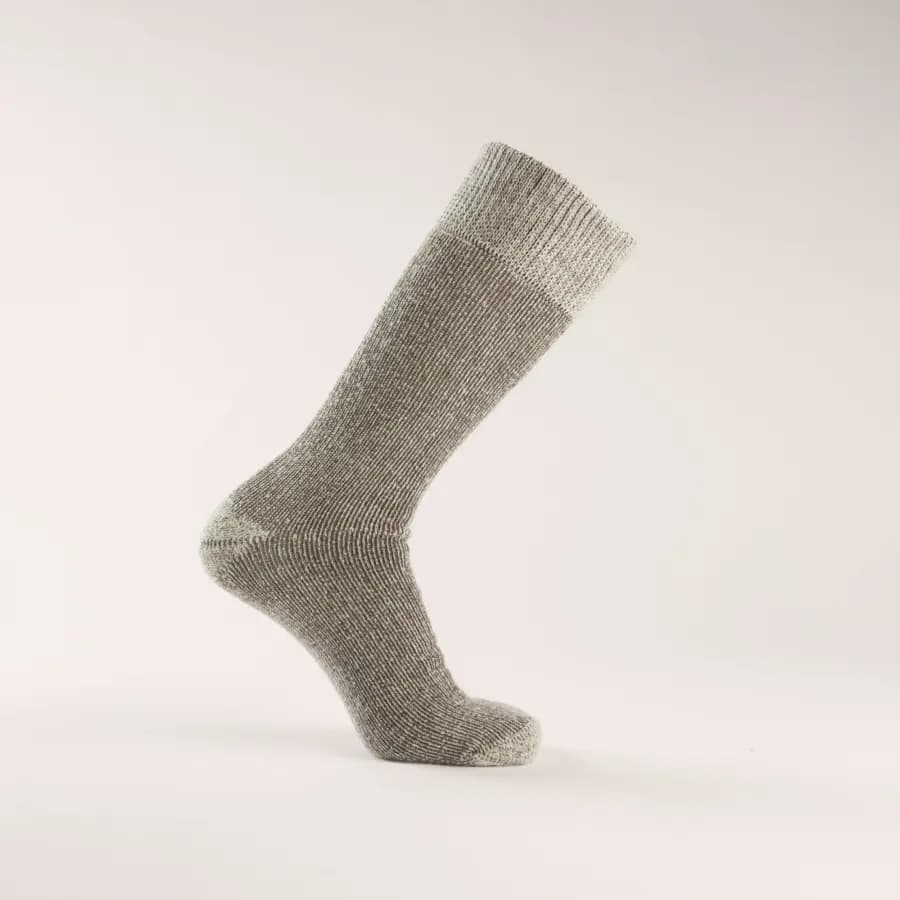 A single gray wool sock displayed on a foot-shaped mannequin against a plain, light background. The sock is mid-calf length and features a ribbed cuff at the top.