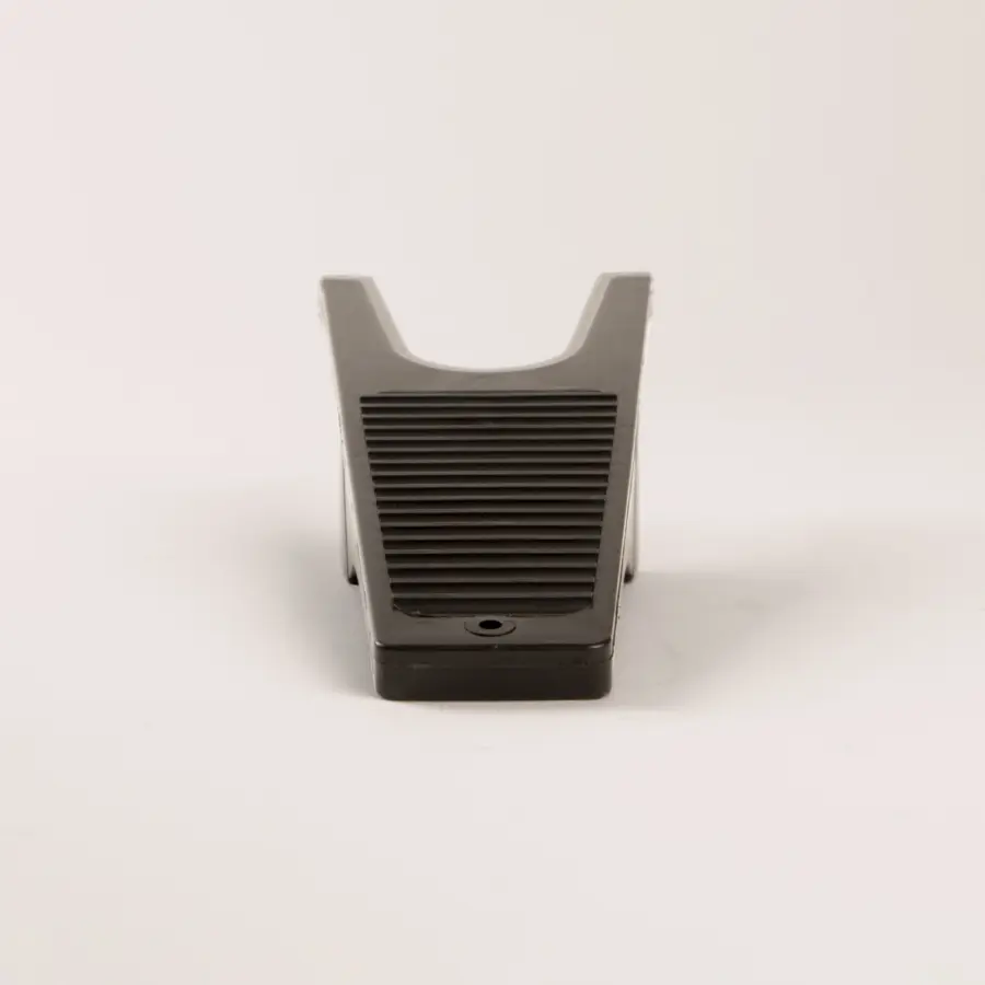 A black plastic boot remover with a grooved, ribbed surface, photographed against a plain white background.