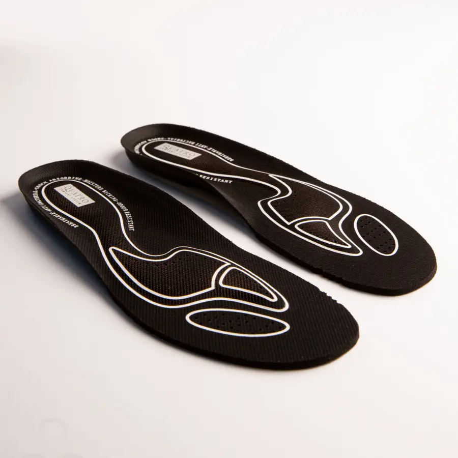 A pair of black shoe insoles with white ergonomic line patterns, displayed on a white surface. The insoles appear cushioned and contoured for foot support.