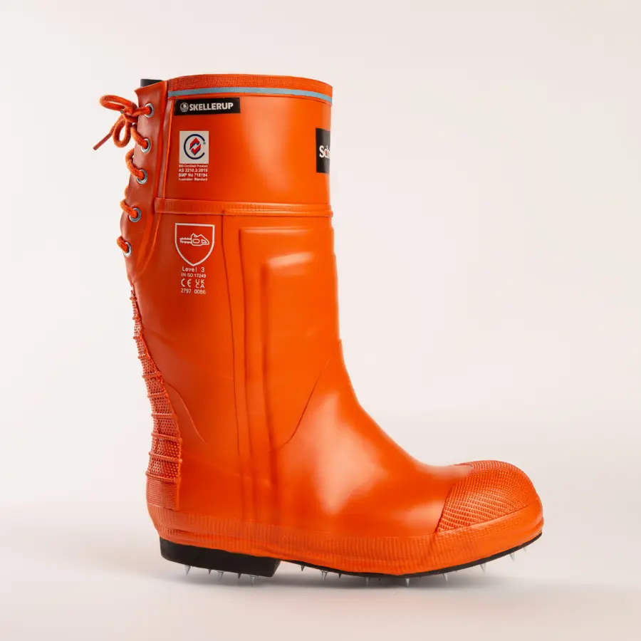A bright orange, high-cut rubber safety boot with a textured toe, black sole, rear laces, and safety certification labels on the side, photographed against a plain white background.