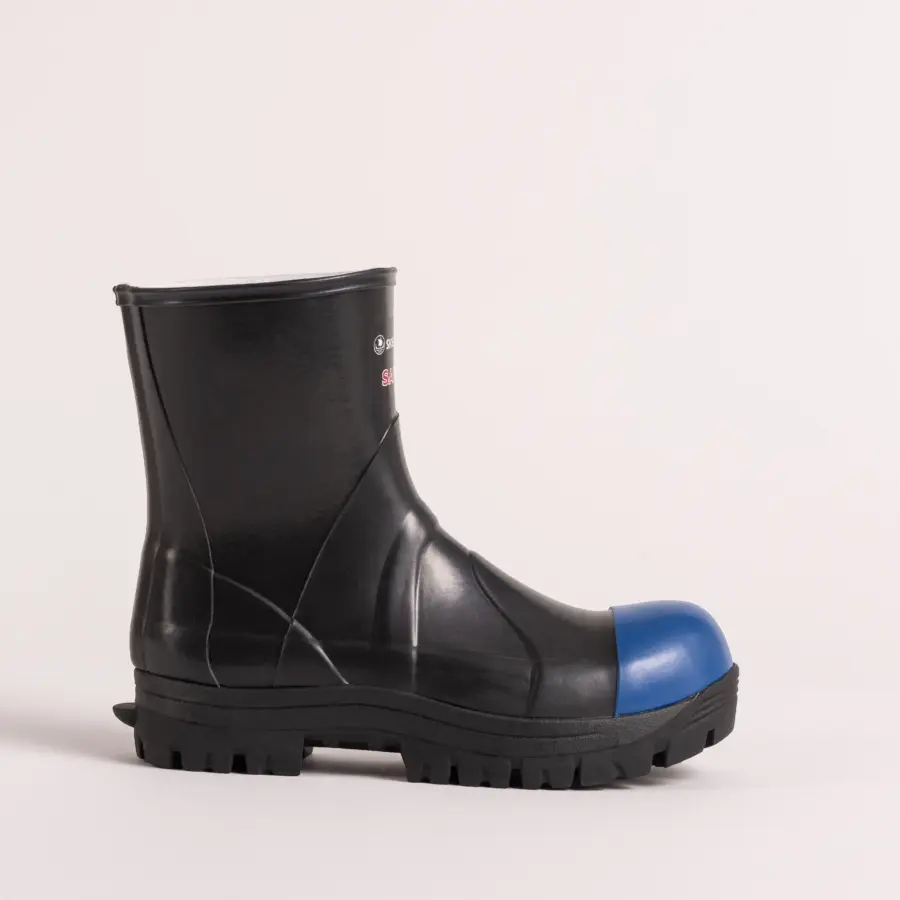 A black rubber work boot with a thick treaded sole and a blue protective toe cap, shown in profile on a plain white background.