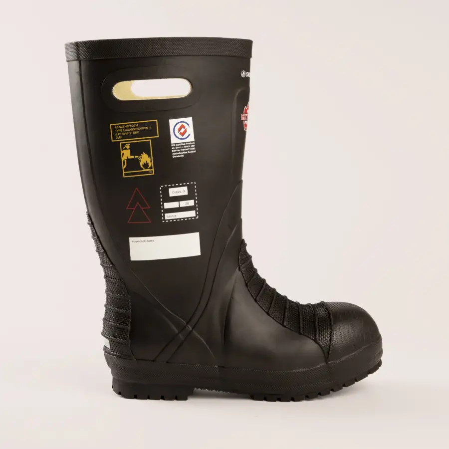 A black industrial safety boot with textured detailing, a reinforced toe, side cut-out handle, and various warning and instruction labels on the side, displayed against a plain light background.