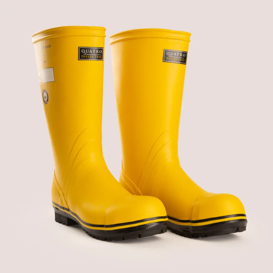 A pair of bright yellow rubber boots with black soles and Quatro Dielectric labels, placed side by side on a light background.