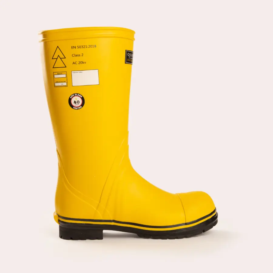 A single yellow rubber safety boot with a black sole, side labeling, and printed certification marks, displayed on a light background.