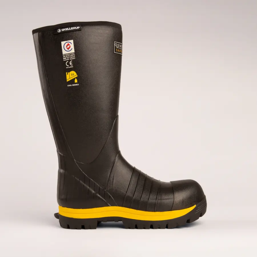 A single black industrial safety boot with a yellow sole and labels on the shaft, photographed on a plain light background.