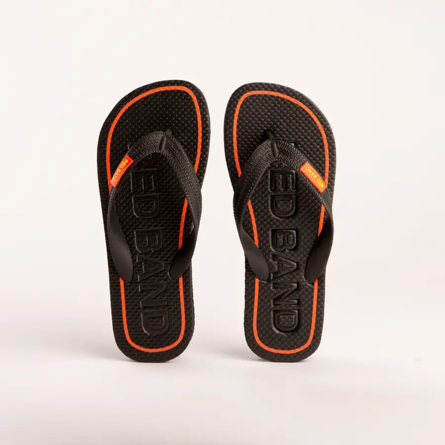 A pair of black flip-flops with textured soles, orange accents along the edge, and the brand name RED BAND embossed on the footbeds, displayed on a light background.