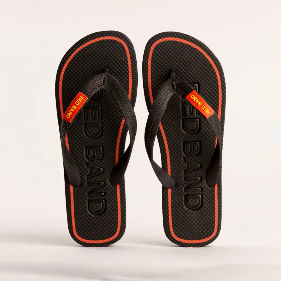 A pair of black flip-flops with red accents and the words RED BAND embossed on the footbeds. The straps also feature a small red label with yellow text that reads RED BAND.