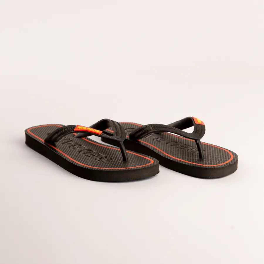 A pair of black flip-flops with a red stripe around the sole and yellow accents on the straps, placed on a plain white background.