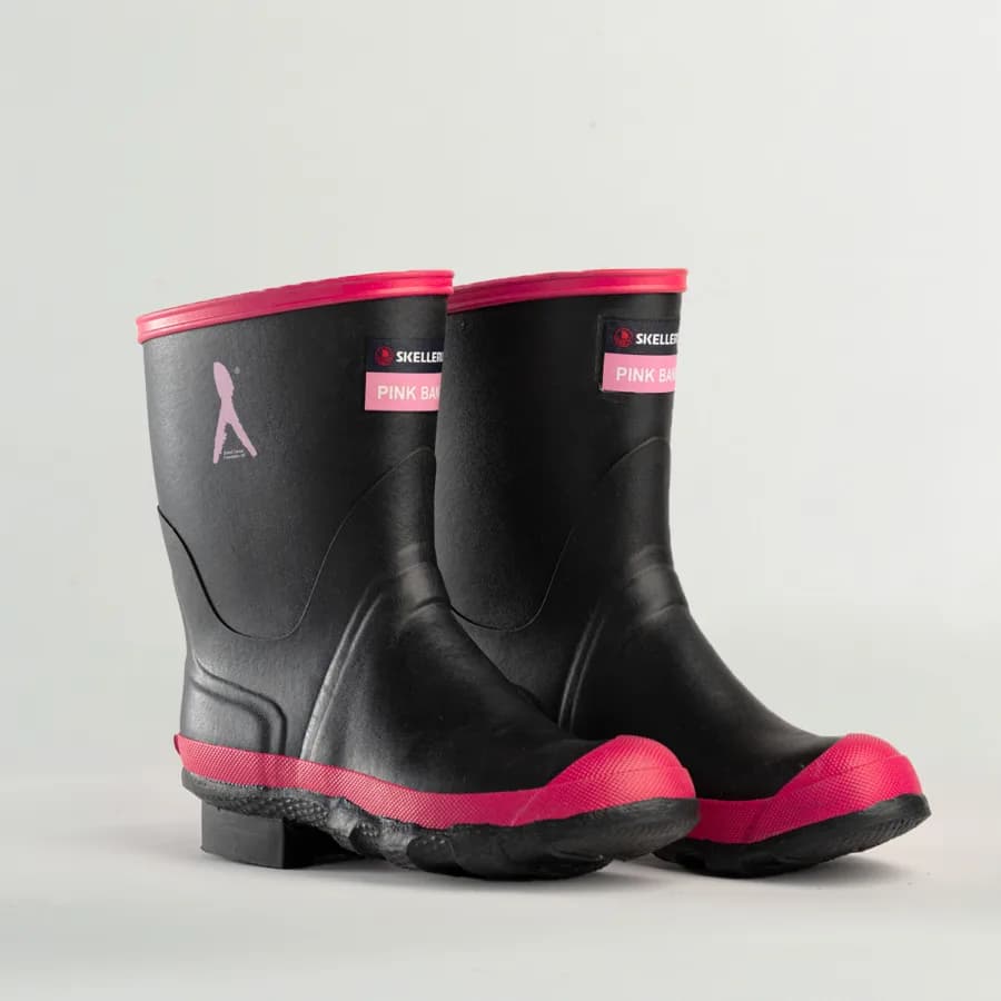 A pair of black rubber boots with bright pink accents on the soles, toes, and top edges, featuring a PINK BAND label and a small silhouette logo on the side, set against a plain light background.