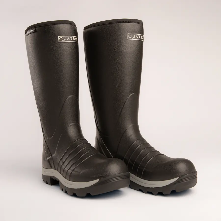 A pair of tall, black rubber boots with rugged soles and gray accents, branded QUATRO on the upper front, standing on a plain light background.