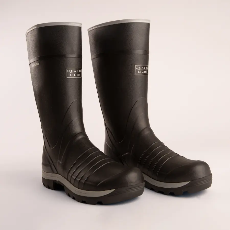 A pair of black rubber boots with textured soles and a Quatro Light logo on the front, standing side by side on a plain light background.