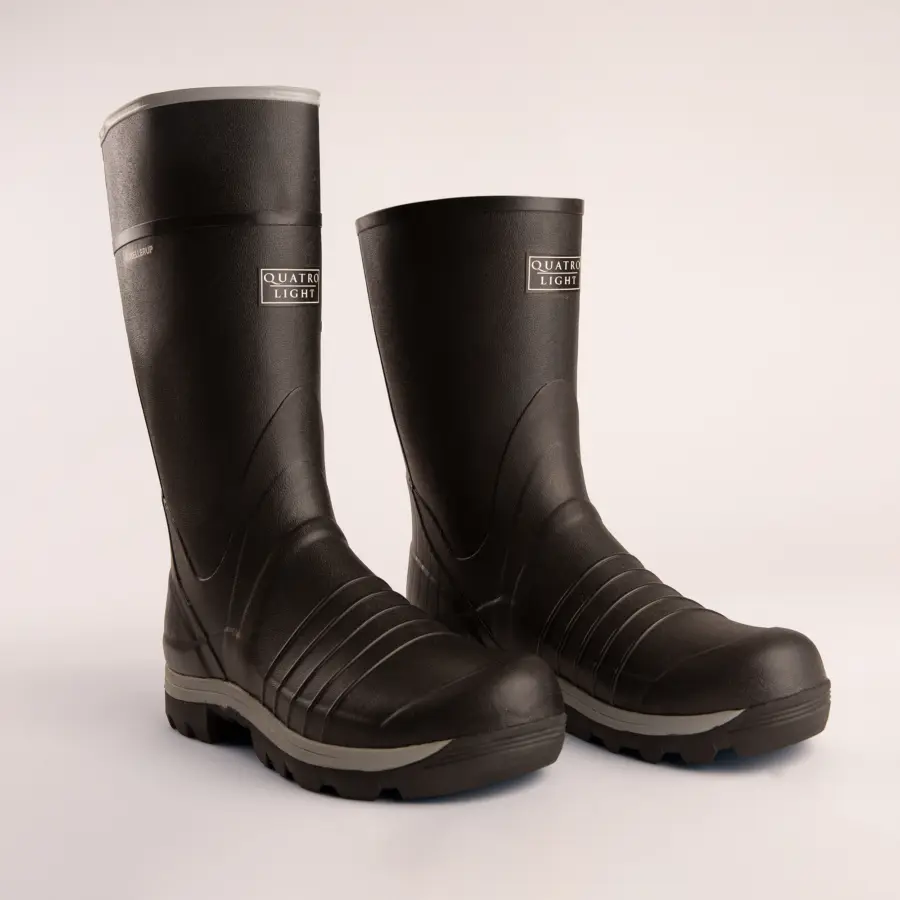 A pair of tall, black rubber boots with textured soles and the label QUATRO LIGHT on the front, standing upright on a light background.