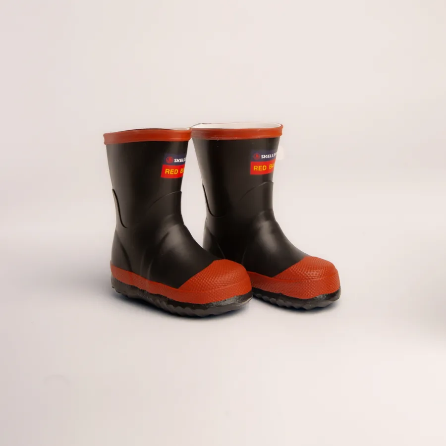 A pair of black rubber boots with bright red soles and toes, standing side by side on a plain white background.