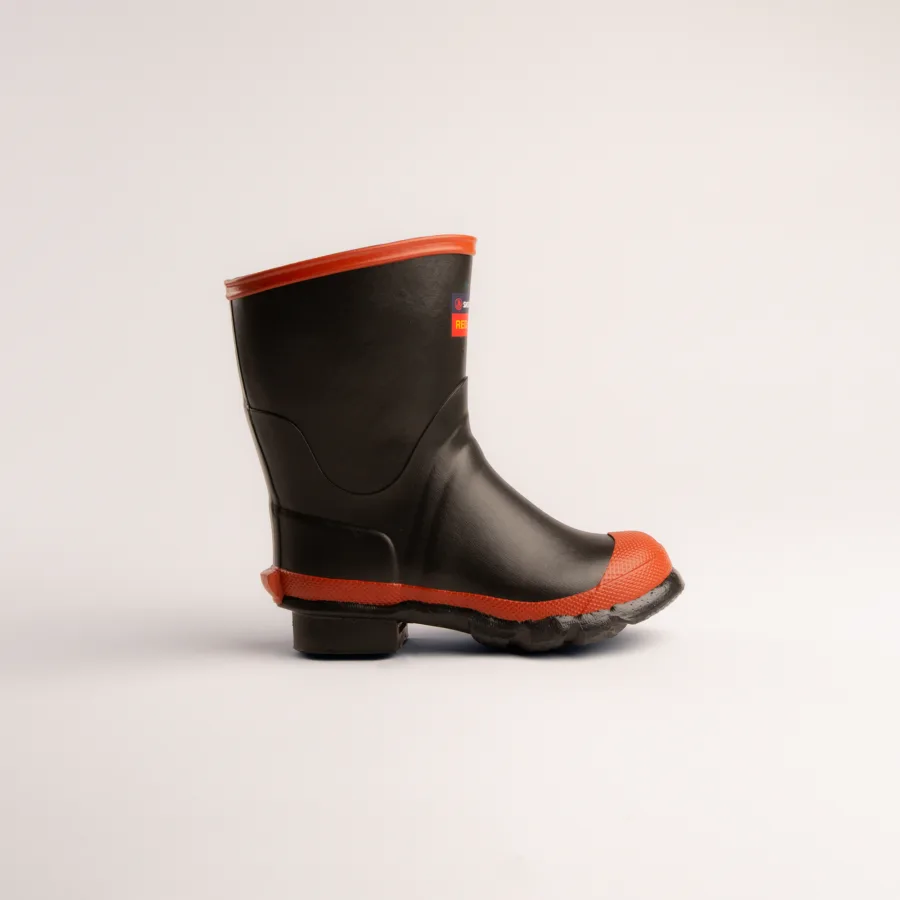 A single black rubber rain boot with an orange sole, toe cap, and rim, positioned upright on a plain white background.