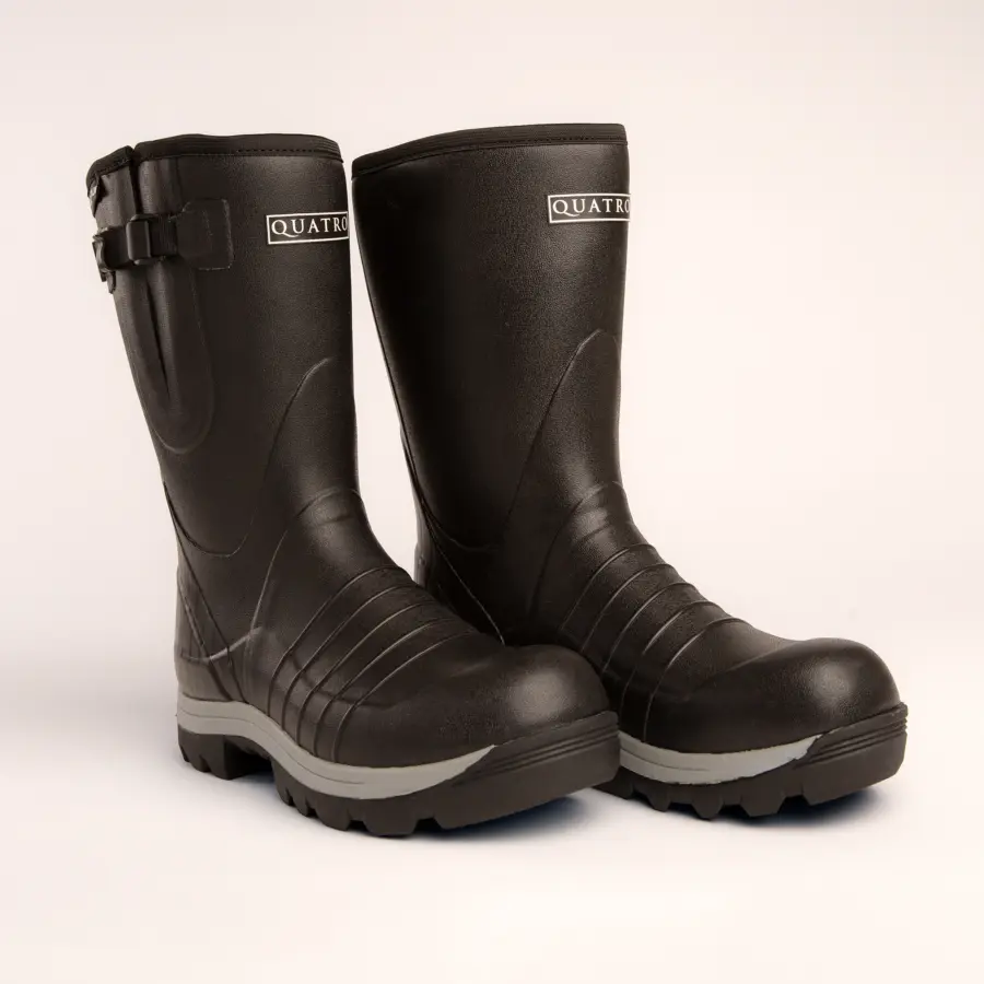 A pair of sturdy black rubber boots with thick soles and a side buckle, branded “QUATRO,” displayed on a white background.