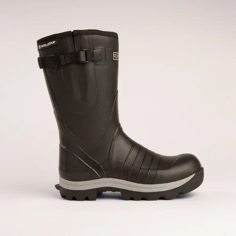 A single black rubber work boot with a thick treaded sole and side buckle, shown in profile on a plain light background.