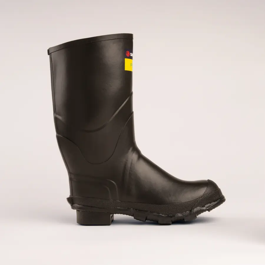 A single black rubber work boot with a textured sole, viewed from the side against a plain light background. There is a small label with red and yellow details near the top of the boot.