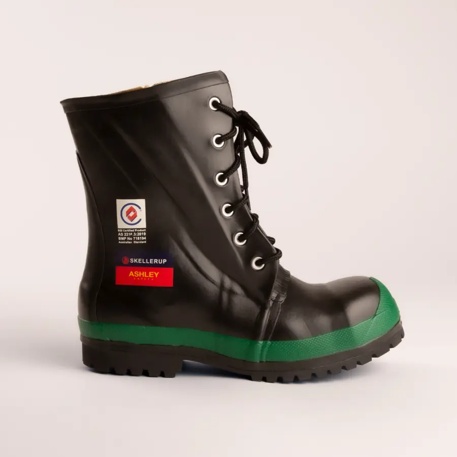 A black lace-up work boot with a green toe cap and textured sole, featuring brand labels Skellerup and Ashley on the side, set against a plain white background.